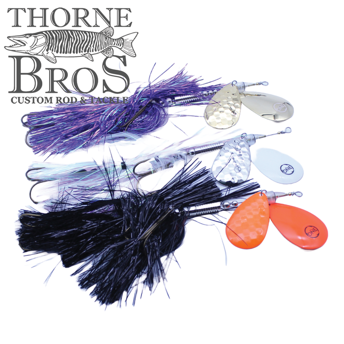Angling Revolution "The One" 9/10 Heavy fishing lures in purple, white, and black with metal spinner blades designed for musky fishing, displayed with Thorne Bros logo.