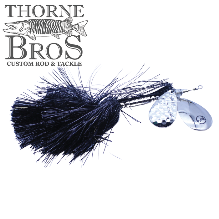 Angling Revolution "The One" 9/10 Heavy fishing lure with black synthetic skirt and shiny silver spinner blades designed for musky fishing, featured by Thorne Bros.