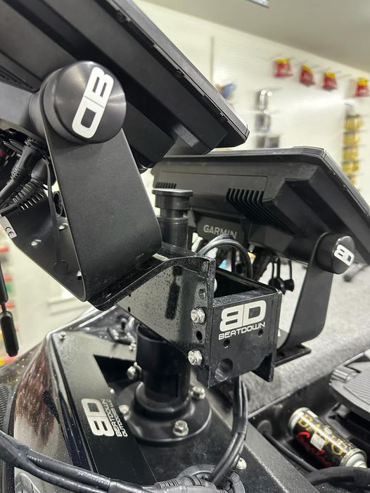 Close-up view of fishing electronics mounts equipped with black knobs labeled BD, featuring Beatdown Outdoors Replacement Graph Knob Set SKU:BD-GK-M6-1 for secure attachment of marine devices and fishing tackle.