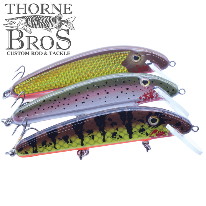 Three detailed B&N Casting Claw - 8" fishing lures in gold, silver with black spots, and yellow-green with black markings, displayed with Thorne Bros logo for fishing tackle.