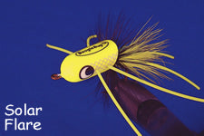 Close-up of a bright yellow Booglebug Bullets #4 fishing lure with feathered tail, designed for musky fishing tackle, shown against a blue background.