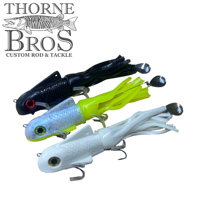 Three Boss Shad Small Hybrid - Shallow fishing lures in black, chartreuse, and white colors with soft rubber skirts and metal spinner blades, displayed against a white background with Thorne Bros logo.
