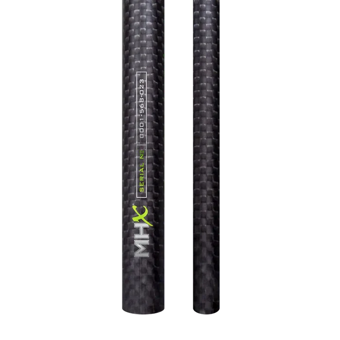 Close-up of two black carbon fiber fishing rod blanks with textured weave pattern, featuring "MHX" label and serial number, part of Bushido 3K Rod Blanks (2 piece) set.