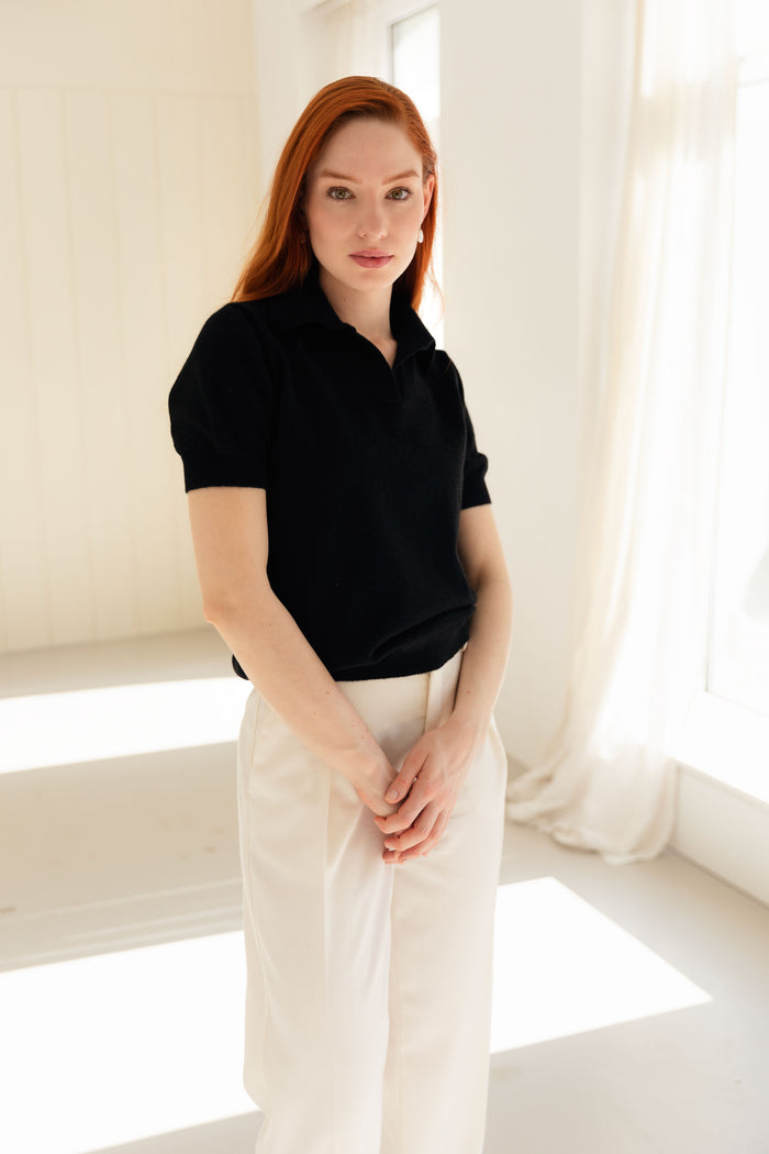 Woman wearing a 100% Mongolian cashmere polo shirt in black.