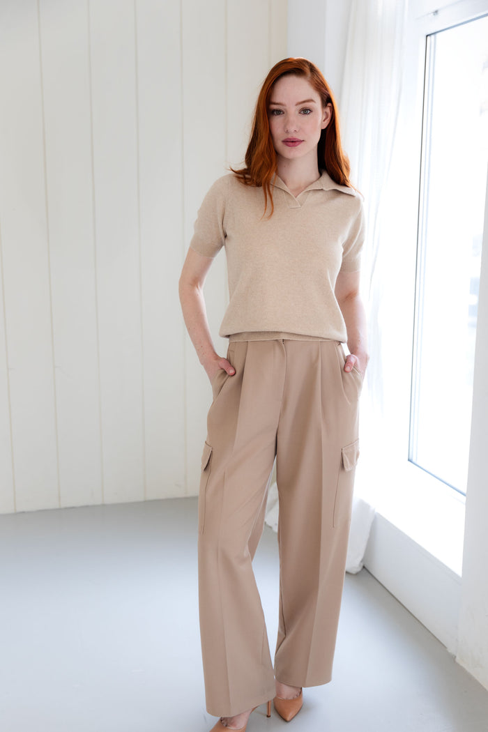 Woman wearing a 100% Mongolian cashmere polo shirt and beige cargo pants