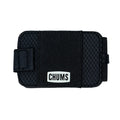 Chums Bandit Bi-Fold Wallet in black with textured exterior and elastic band closure featuring a white logo patch, designed for secure and compact storage.