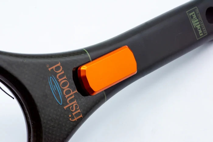 Close-up of a black fishing net handle with an orange rectangular Cling Mag Grab Net Rack clipped onto it, designed for secure attachment and easy access during fishing.