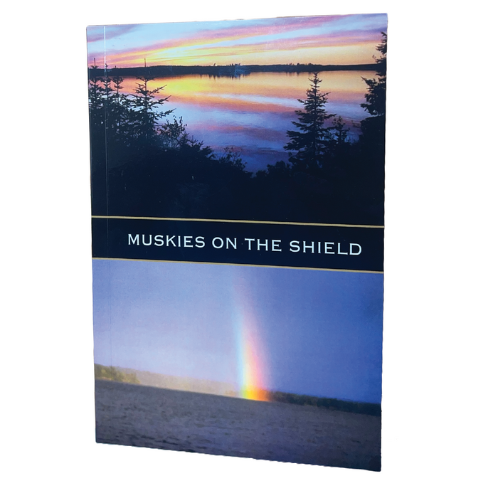 Dick Pearson - Muskies On The Shield Book with a cover showing a serene lake at sunset and a faint rainbow over the water, highlighting musky fishing and natural scenery.