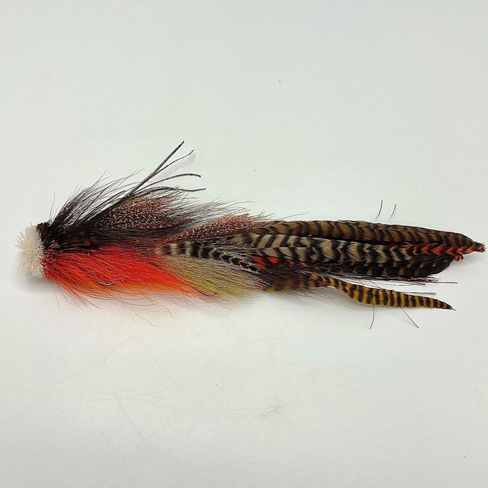 Close-up of a colorful fishing lure with orange, black, and brown feathers designed for fly fishing, identified as Double Buford Urban Fly Co.