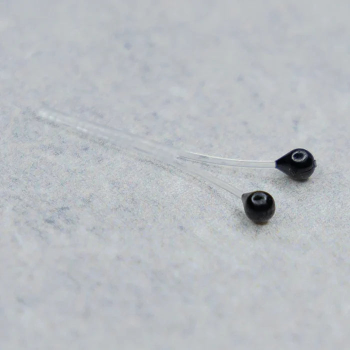 Easy Shrimp Eyes feature small, black, bead-like eyes attached to clear stems, designed for use in custom fishing tackle and lure crafting.