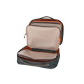 Open compact fishing tackle bag with multiple zippered mesh compartments and padded storage, designed for organizing gear in the Fishpond Backwater Fly Tying Kit.