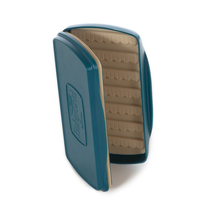 Fishpond Tacky Fly Boxes Silicone shown open, with durable teal exterior and soft beige silicone interior designed to securely hold multiple fishing lures and tackle.