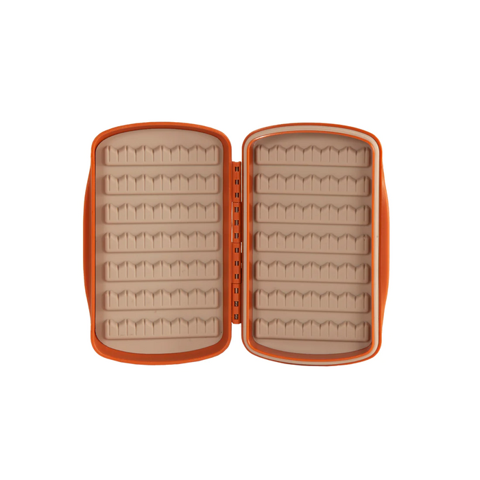 Fishpond Tacky Fly Boxes Silicone in orange, open to show soft silicone interior with multiple rows of slots for securely holding fishing lures and tackle.