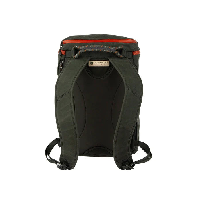 Fishpond River Bank Backpack shown from the back, featuring padded shoulder straps, durable dark green fabric, and a small top zipper pocket, designed for fishing tackle and outdoor use.