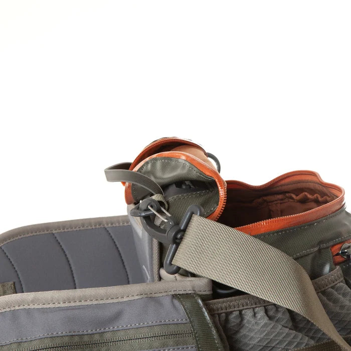 Fishpond Stormshadow Lumbar Pack shown open with visible compartments and adjustable strap, designed for convenient storage of fishing tackle and gear during outdoor fishing activities.