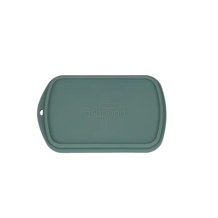 Fishpond Tacky Grande Fly Dock MagPad in muted green, a rectangular soft silicone mat designed for fly fishing with raised edges and embossed logo for secure fly placement and protection.