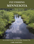 Cover of Fly Fishing Minnesota showing a scenic river surrounded by dense greenery with a person fly fishing on the riverbank, highlighting fishing rods and reels in a natural outdoor setting.