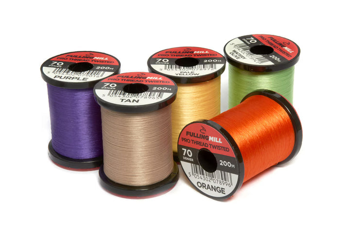 Five spools of Fulling Mill Pro Thread Twisted 70 Den fishing thread in purple, tan, yellow, green, and orange colors arranged on a white background.