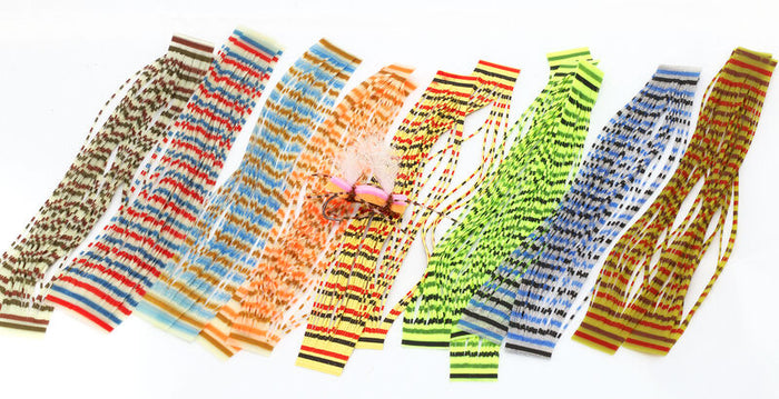 Hareline Triple Barred Heavy Duty Silicone Legs in various colors including brown, red, orange, yellow, green, blue, and yellow-orange, displayed for fishing lure customization.