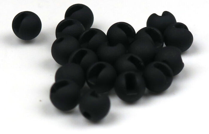 Close-up of small, matte black, slotted fishing beads designed for tackle, identified as Hareline Tungsten Beads Painted (Slotted), used in fishing rods and lure setups.