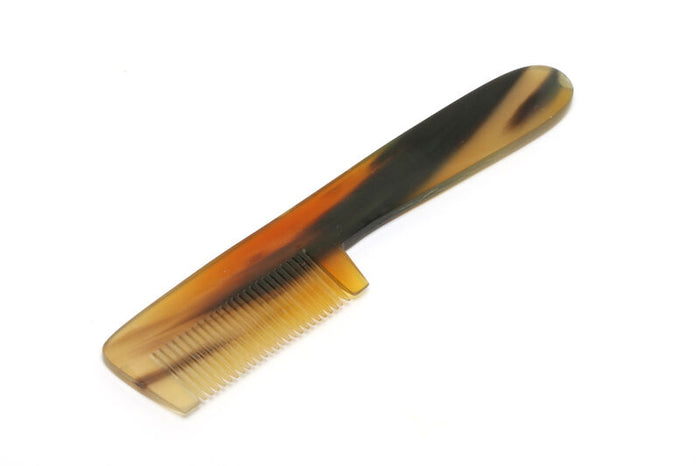 Hareline Underfur Bone Comb with a smooth, polished surface featuring natural brown and tan marbled patterns, designed for precise grooming and fly tying.