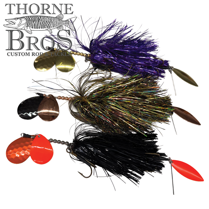 Three Hunsy Tails 7/8 XL Banger fishing lures with colorful skirts in purple, green, and black, each equipped with metallic spinner blades for musky fishing tackle.