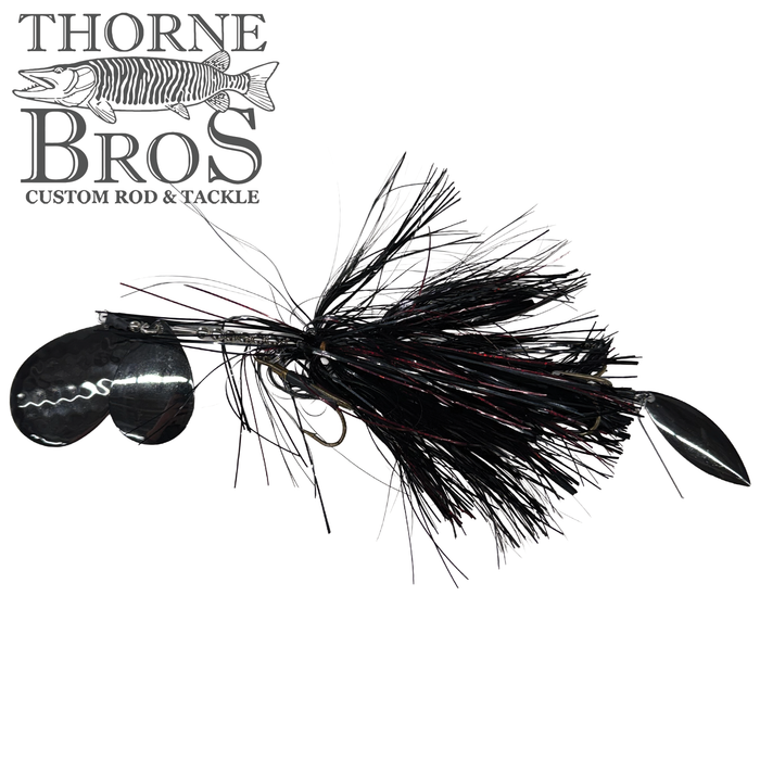 Close-up of a Hunsy Tails 8/10 Banger fishing lure with black and red synthetic fibers and two metallic spinner blades, designed for musky fishing.