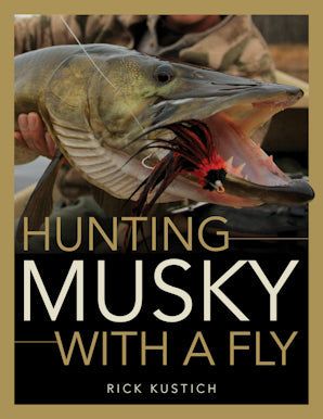 Cover of a fishing guide titled Hunting Musky With A Fly showing a close-up of a large musky fish with a red and black fly lure in its open mouth, highlighting fishing tackle and fly fishing techniques.