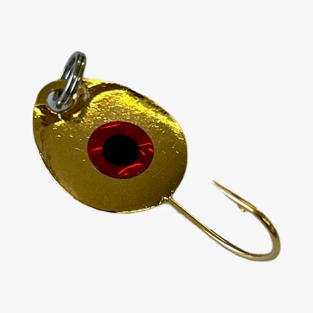 Close-up of a gold-colored JB Lures Tungsten Gem-N-Eye Jig fishing lure with a red and black eye detail and a sharp single hook, designed for effective fishing tackle use.