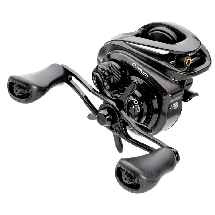Lew's Custom Casting Reel in black, featuring dual ergonomic handles and precision adjustment dials, designed for smooth casting and reliable performance in fishing tackle.