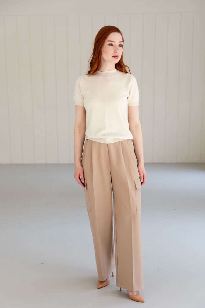 Woman wearing a 100% Mongolian cashmere t-shirt and beige elegant trousers.