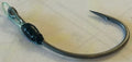Close-up of Limitless Felix's HALO Ryugi fishing hook featuring a sharp curved point and durable black and metallic finish, designed for musky and ice fishing tackle.