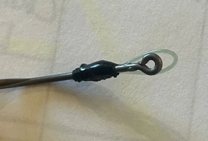 Close-up view of the tip guide on the Limitless Felix's HALO Ryugi fishing rod, showing the secure black wrap and metal loop designed for smooth line flow.