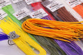 Linguini Foam in various colors including yellow, chartreuse, red, brown, purple, and orange, displayed alongside a fishing lure featuring foam strands and feathers.