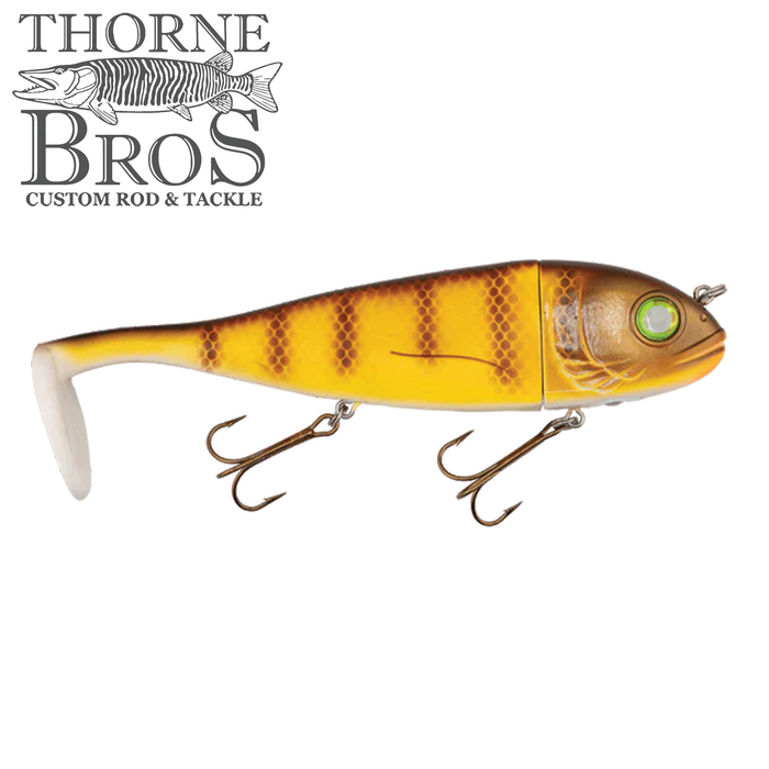 Livingston Lures Magnus fishing lure in yellow and brown with a segmented body and two treble hooks, designed for freshwater musky fishing.