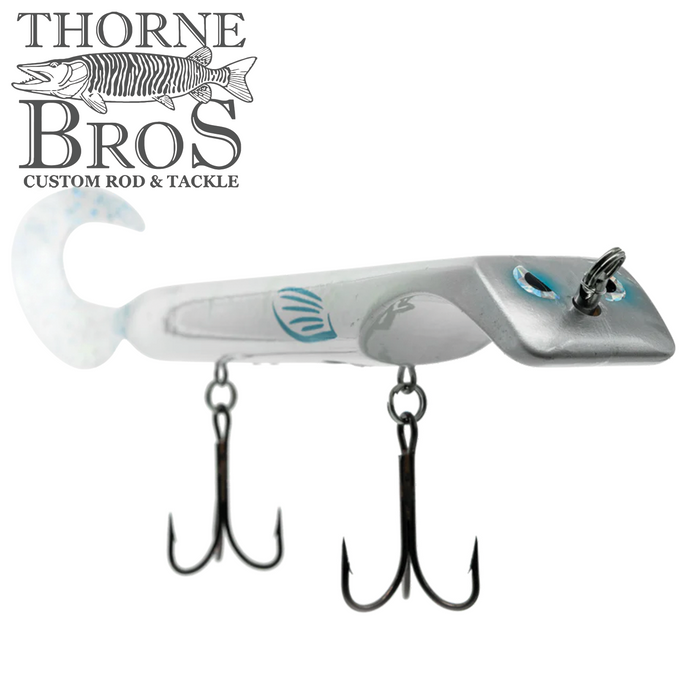 Livingston Lures Titan fishing lure in white and silver with realistic blue eye detail, featuring two sharp treble hooks and a curved tail for lifelike movement.