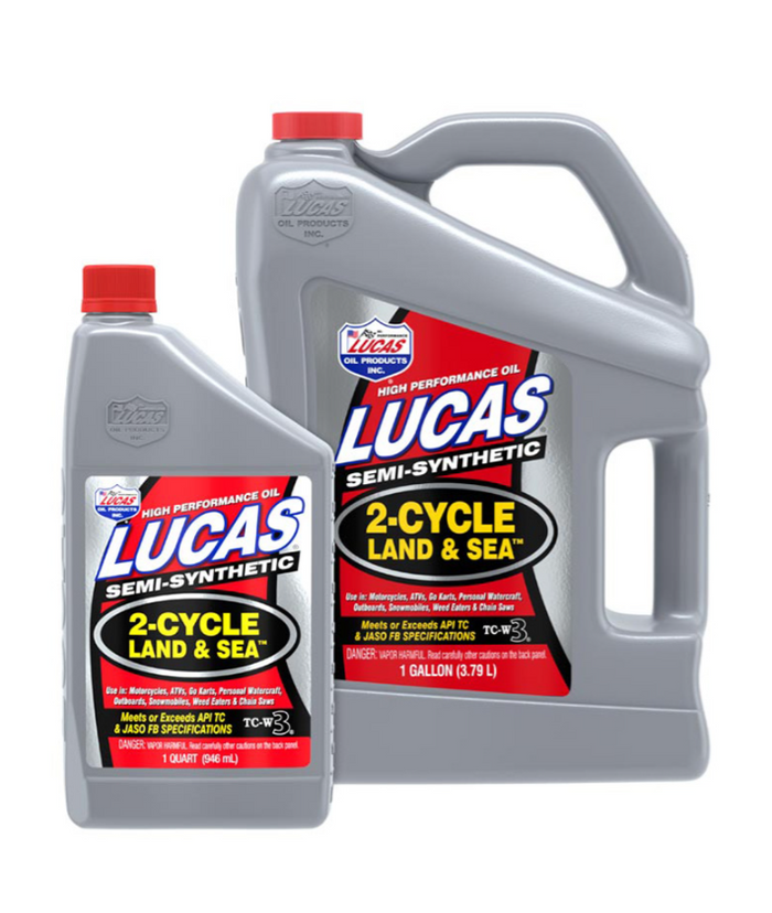 Two sizes of Lucas Land & Sea 2-Cycle Oil containers, one quart and one gallon, both gray with red caps, designed for use with marine and outdoor engines.