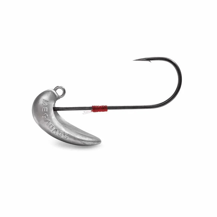 Close-up image of a silver fishing jig head with a sharp black hook, featuring the engraved name Megabass Magdraft Head, designed for musky fishing tackle.