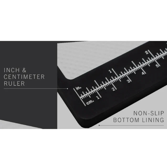 Close-up of the MFC Fly Tying Mat corner featuring an inch and centimeter ruler and a non-slip bottom lining on a textured surface for precise measurement and stable use.