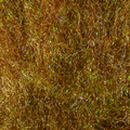 Close-up image of iridescent fibers in shades of brown and green used as fishing lure material, specifically the MFC UV Chub Dub for fly fishing and tackle crafting.