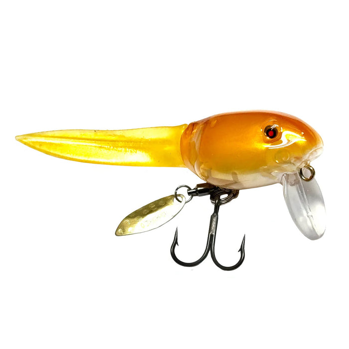 Nishine Lure Works BQ Otama Wakebait featuring a translucent orange and yellow body with a curved lip, detailed eyes, a metal spinner blade, and twin treble hooks for fishing tackle use.