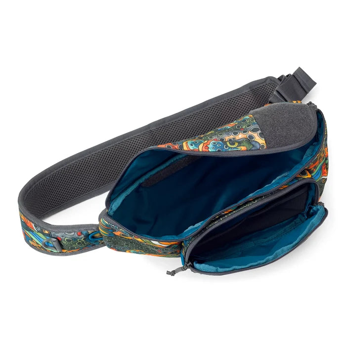 Orvis Mini Sling Pack in colorful patterned fabric with adjustable padded strap, featuring multiple zippered compartments and a spacious interior for fishing tackle organization.