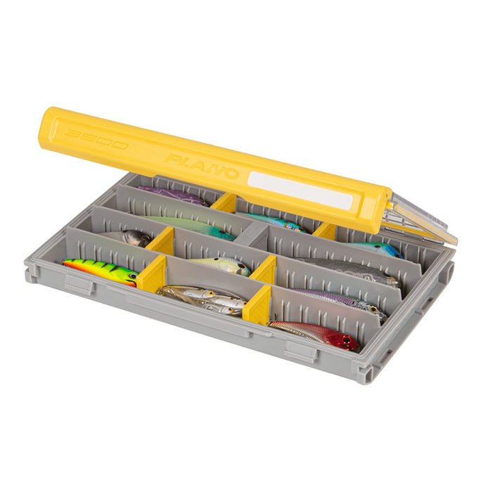 Plano EDGE 3600 Box with a transparent yellow lid holding multiple compartments filled with various colorful fishing lures, designed for organized fishing tackle storage.
