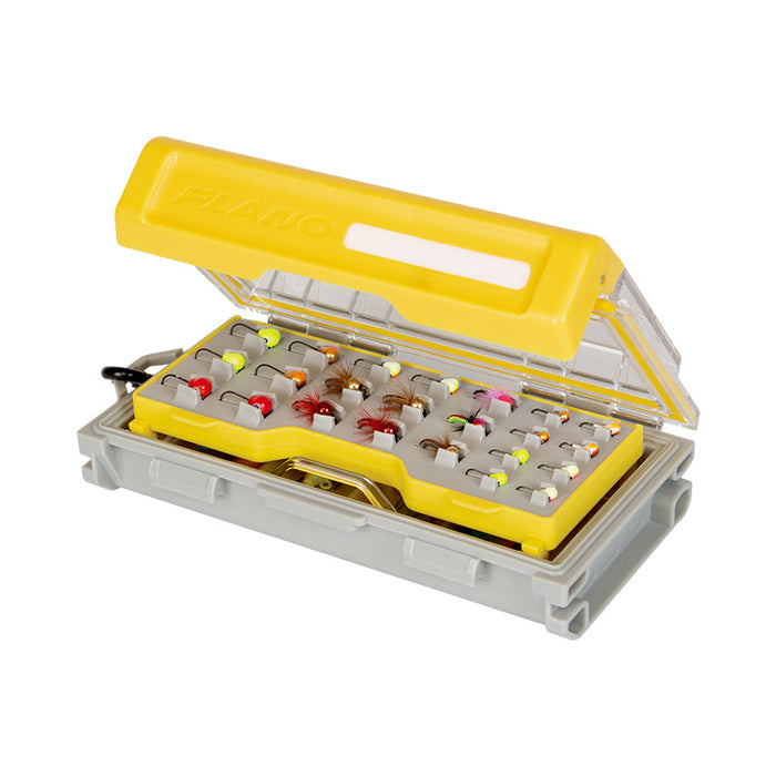 Plano EDGE Micro Jig Box in yellow and gray, open to show organized compartments holding various colorful fishing jigs and tackle inside a clear lid container.