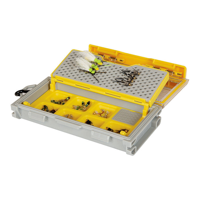 Plano EDGE Micro Magnetic Fly Box open to show yellow and gray compartments holding various fishing flies and tackle for organized fishing gear storage.