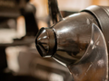 Precision Sonar Trolling Motor Prop Nut - Minn Kota Quest PN:PNMKQ-BLK, close-up view showing a black, textured metal nut attached to a motor component, designed for fishing tackle and marine electronics.