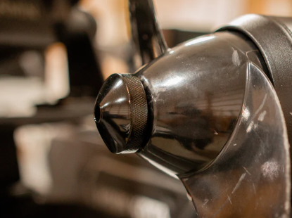 Precision Sonar Trolling Motor Prop Nut - Minn Kota Quest PN:PNMKQ-BLK, close-up view showing a black, textured metal nut attached to a motor component, designed for fishing tackle and marine electronics.