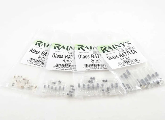 Clear plastic packages of Rainy's Glass Rattles in various sizes, small cylindrical fishing tackle components used to create noise in fishing lures for enhanced attraction.