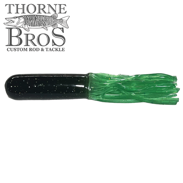 Close-up of a black and green fishing lure tube with a solid black head and flowing green skirt featuring small glitter flecks, designed for use with the Red October Replacement Tubes - 10" (Tube Rig Sold Separately).