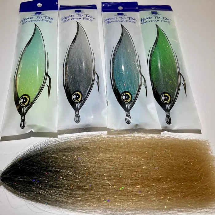 Four packaged Renzetti Head to Tail Baitfish Fade fishing lures in various colors displayed upright against a white background, with one loose baitfish-patterned lure made of synthetic fibers laid below them.